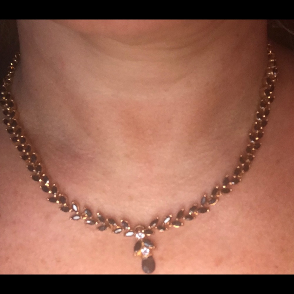 Metallic gold with black and white stone